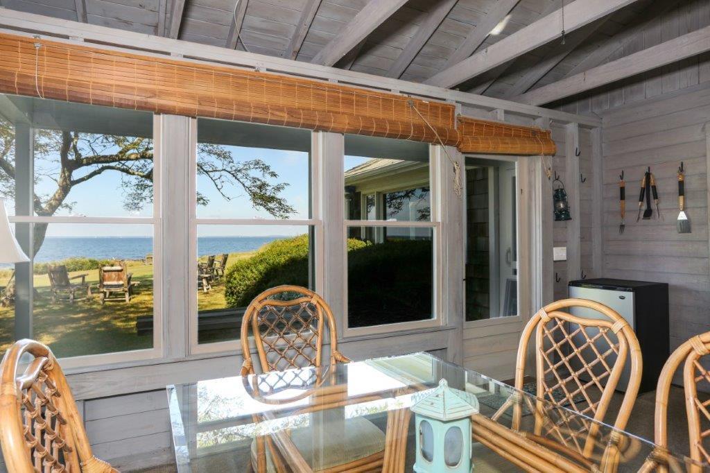 114 Quaker Road Falmouth, MA 02540 - Photo 16 of 35 a dining room with furniture wooden floor and a rug