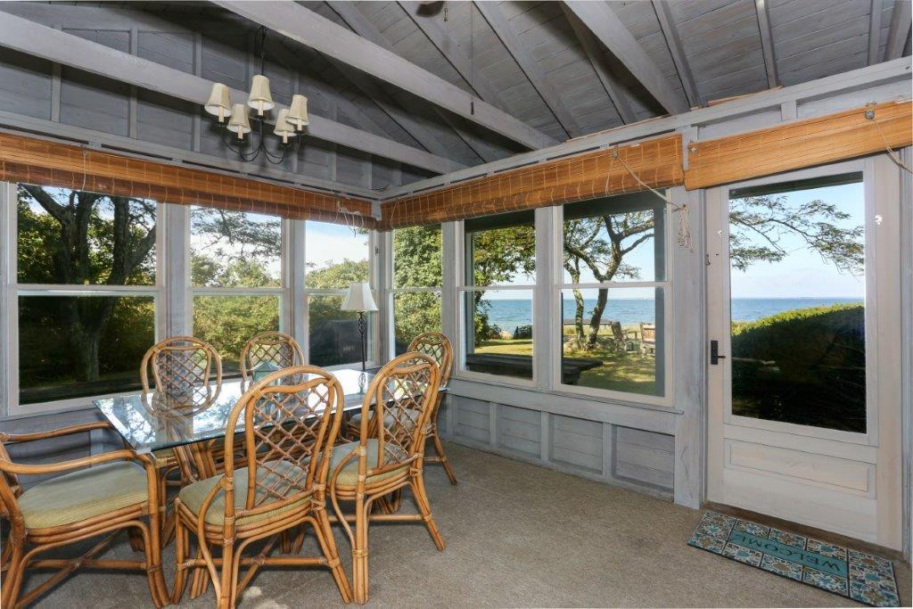 114 Quaker Road Falmouth, MA 02540 - Photo 17 of 35 a view of a dining room with furniture large windows and wooden floor