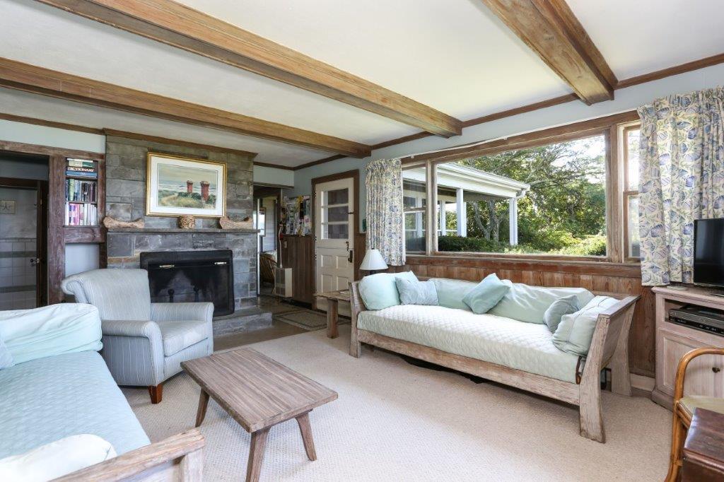 114 Quaker Road Falmouth, MA 02540 - Photo 9 of 35 a living room with furniture and a fireplace