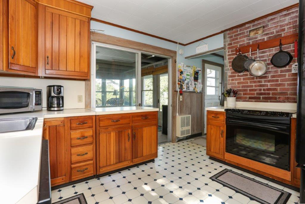 114 Quaker Road Falmouth, MA 02540 - Photo 10 of 35 a kitchen with wooden cabinets and a stove top oven