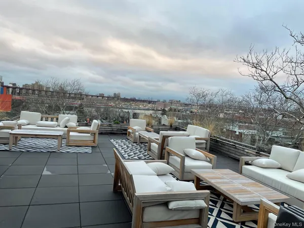 a terrace with outdoor seating and city view