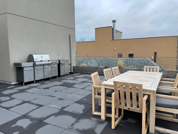 a view of a patio with table and chairs