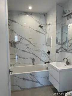 a bathroom with a bathtub and shower