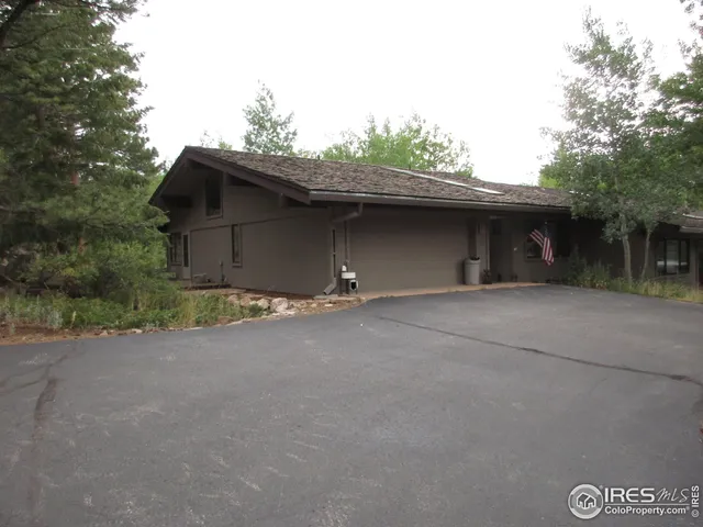 a kitchen with stainless steel appliances granite countertop a table chairs and a refrigerator