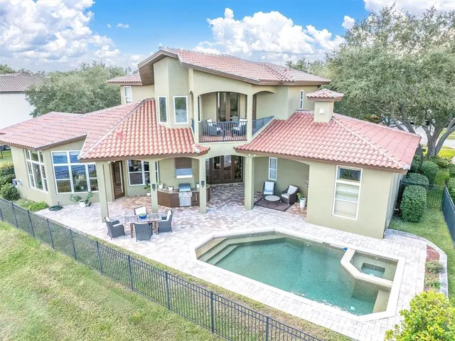 a living room with fireplace furniture and a large window