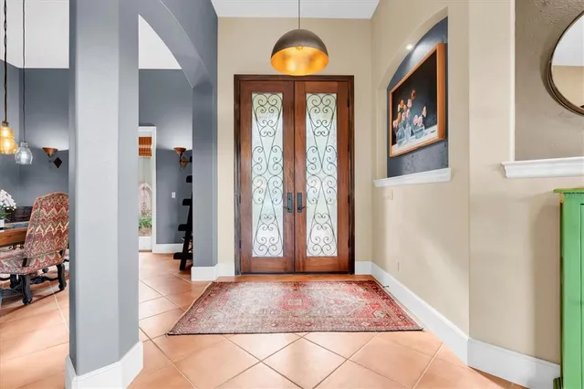 a large kitchen with a large counter top space appliances and windows