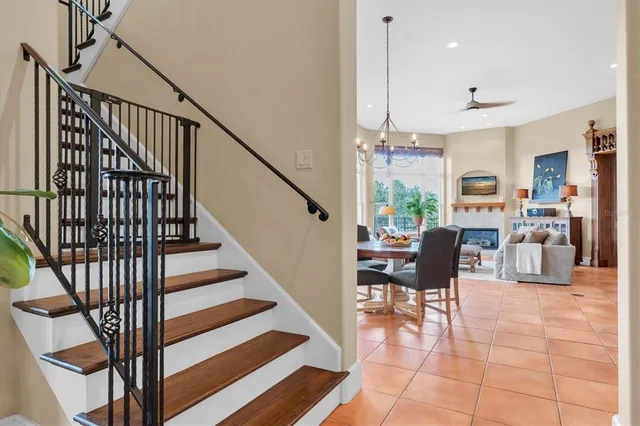 a kitchen with stainless steel appliances granite countertop a sink a stove a window and chairs