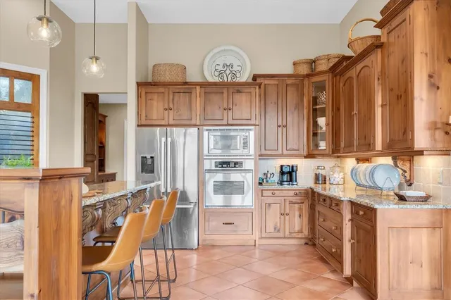 a spacious bedroom with a bed and a chandelier