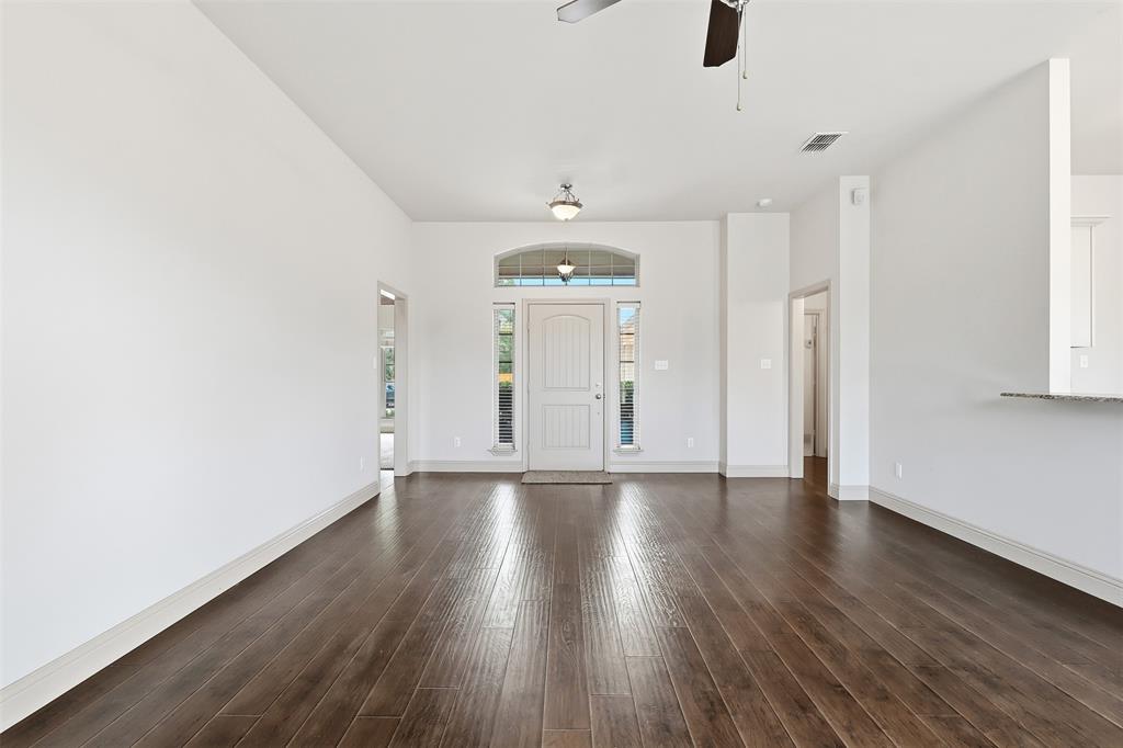 2512 Guinn Farms Road Tyler, TX 75707 - Photo 17 of 29 an empty room with wooden floor and windows