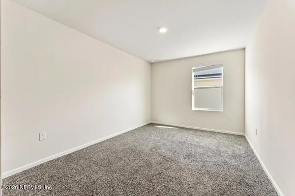 an empty room with a empty space and a window