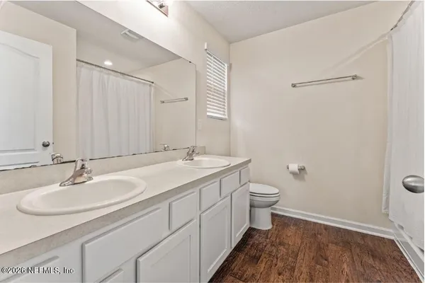 a bathroom with a double vanity sink and a mirror
