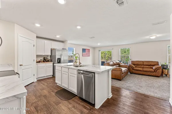 a kitchen with sink refrigerator and window