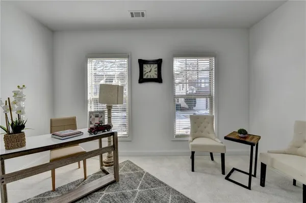 a view of a livingroom with furniture and a window