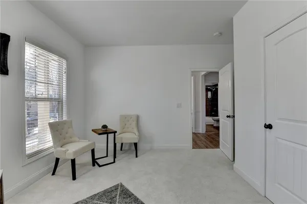 a view of a livingroom with furniture and a window