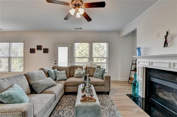a living room with furniture and a fireplace