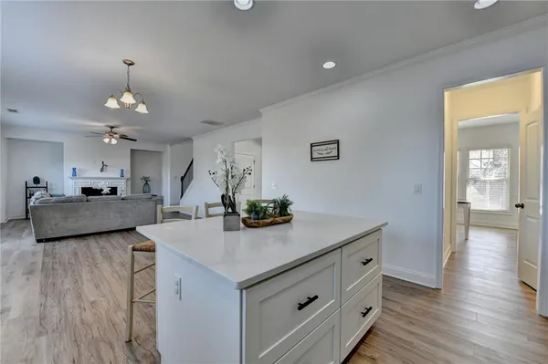 a spacious bedroom with a bed a couch and a chandelier