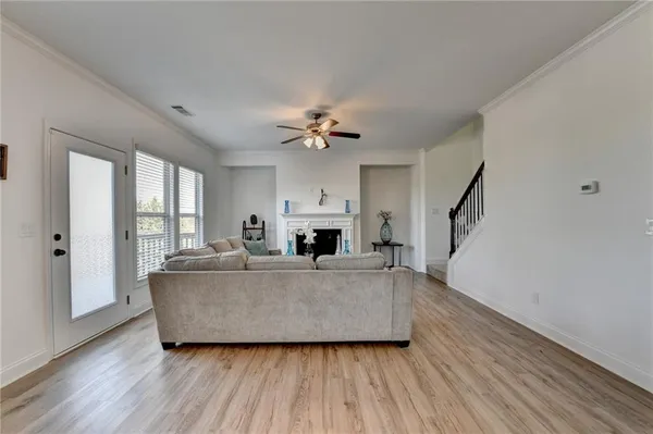 a spacious bedroom with a bed a couch and a window