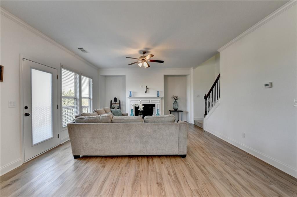 3670 Baxley Ridge Drive Suwanee, GA 30024 - Photo 29 of 64 a living room with furniture and a fireplace