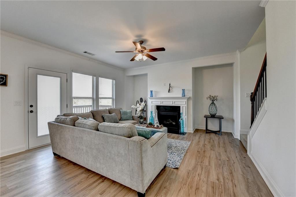 3670 Baxley Ridge Drive Suwanee, GA 30024 - Photo 30 of 64 a living room with furniture and a fireplace