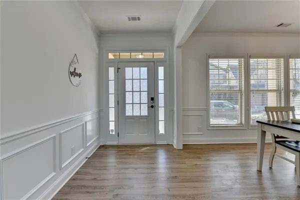 a view of room with window and wooden floor