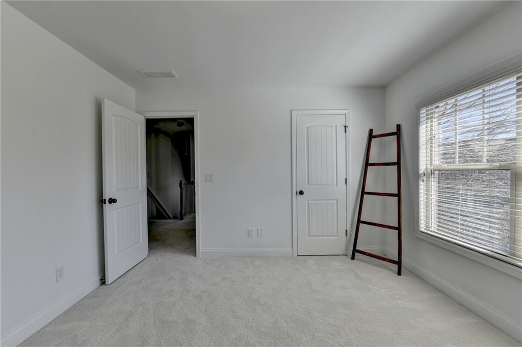 3670 Baxley Ridge Drive Suwanee, GA 30024 - Photo 33 of 64 an empty room with windows
