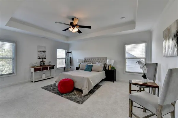 a spacious bathroom with a granite countertop sink a mirror and a shower