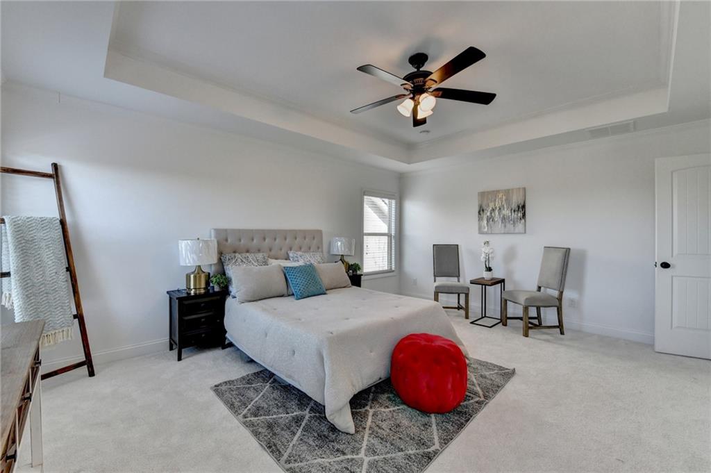 3670 Baxley Ridge Drive Suwanee, GA 30024 - Photo 37 of 64 a bedroom with a bed and a chandelier