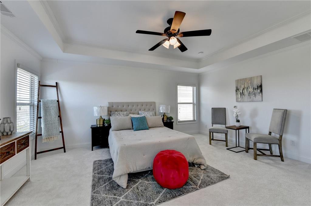 3670 Baxley Ridge Drive Suwanee, GA 30024 - Photo 40 of 64 a bedroom with a bed a chandelier and a dresser