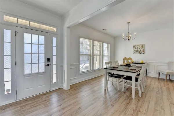 a view of a workspace with wooden floor and a window