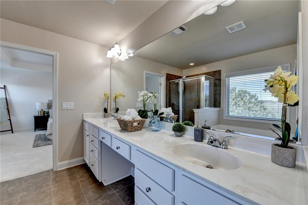 3670 Baxley Ridge Drive Suwanee, GA 30024 - Photo 44 of 64 a bathroom with double vanity and a mirror