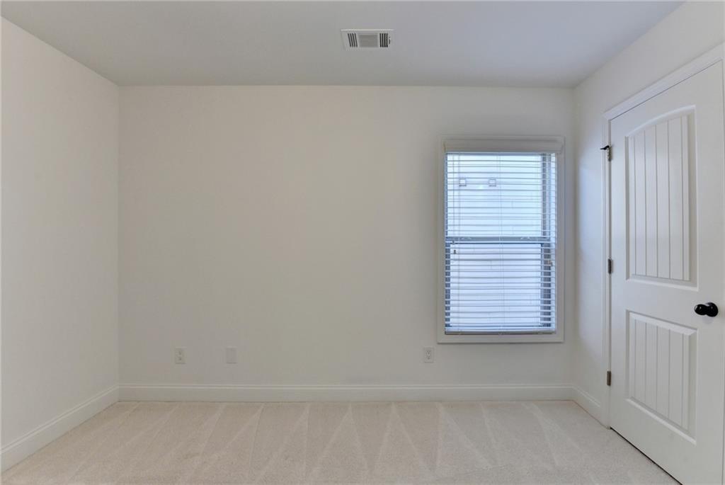 3670 Baxley Ridge Drive Suwanee, GA 30024 - Photo 49 of 64 a view of an empty room with a window