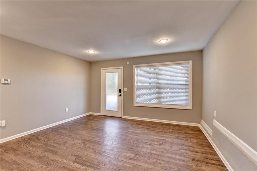 3670 Baxley Ridge Drive Suwanee, GA 30024 - Photo 54 of 64 an empty room with wooden floor and windows