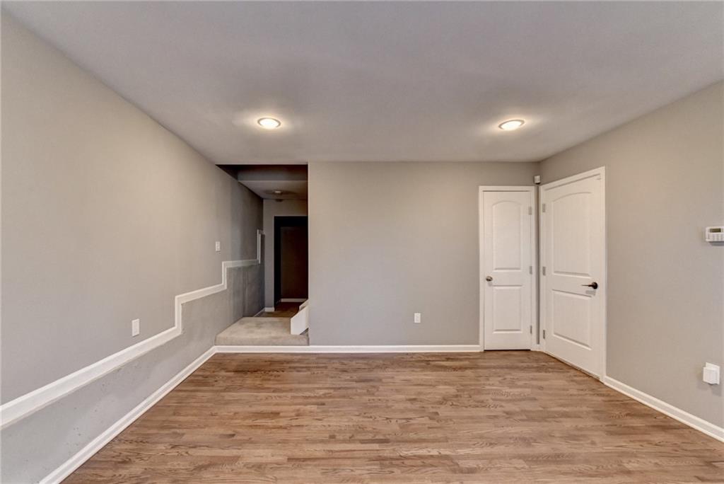 3670 Baxley Ridge Drive Suwanee, GA 30024 - Photo 56 of 64 a view of an empty room with wooden floor