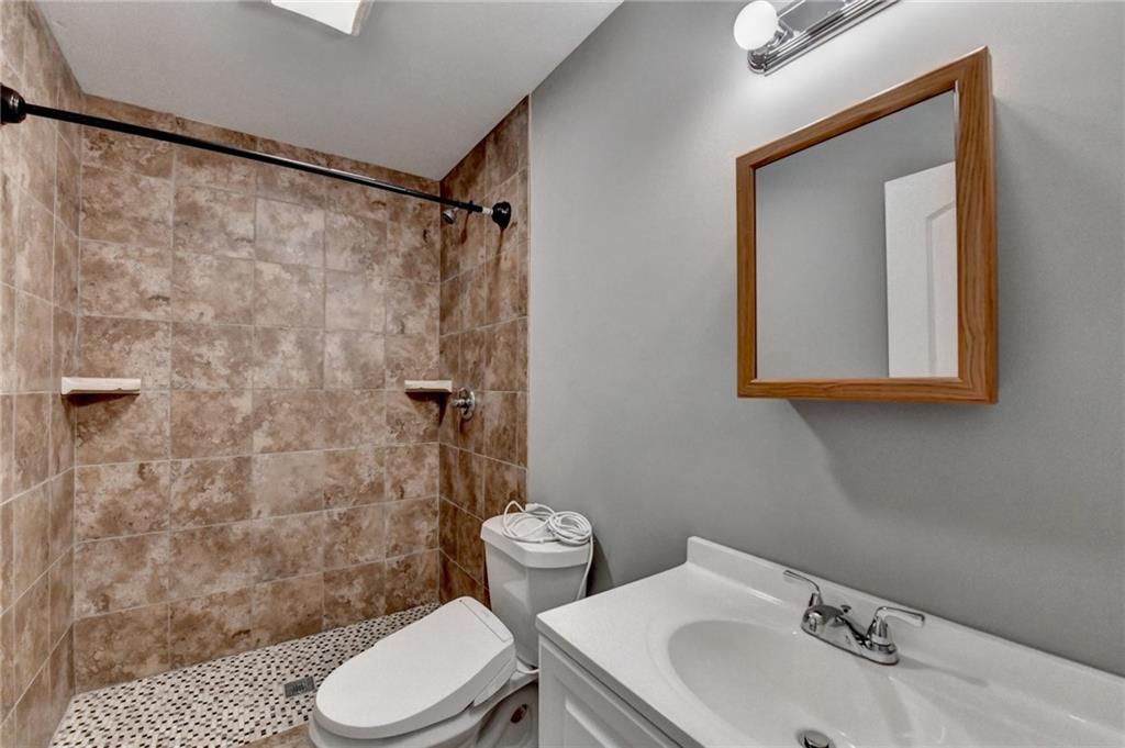 3670 Baxley Ridge Drive Suwanee, GA 30024 - Photo 59 of 64 a bathroom with a sink a toilet and shower