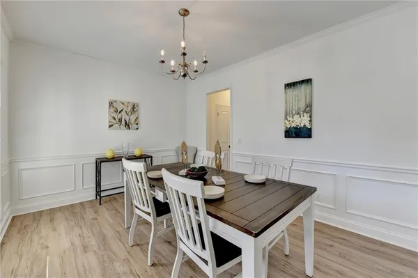 a view of a dining room with furniture and wooden floor