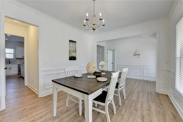 a view of a dining room with furniture and wooden floor