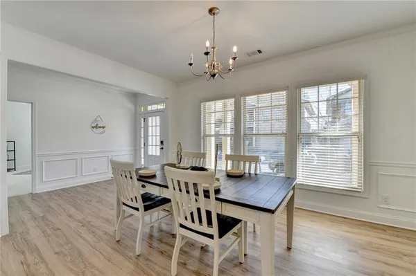 a view of a dining room with furniture window and wooden floor