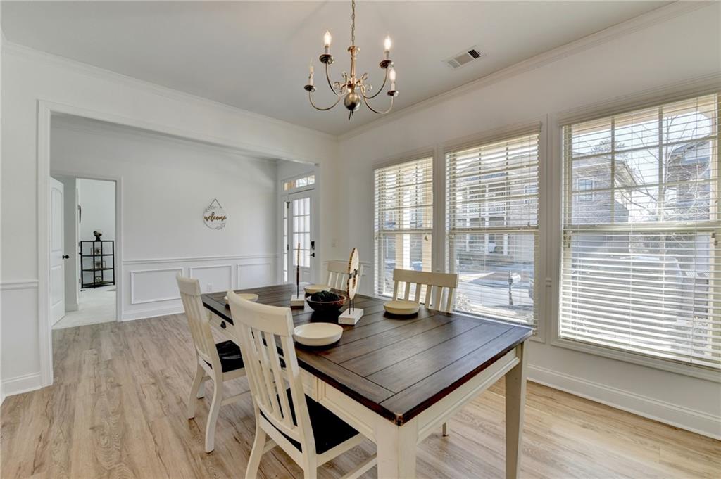 3670 Baxley Ridge Drive Suwanee, GA 30024 - Photo 9 of 64 a view of a dining room with furniture window and wooden floor