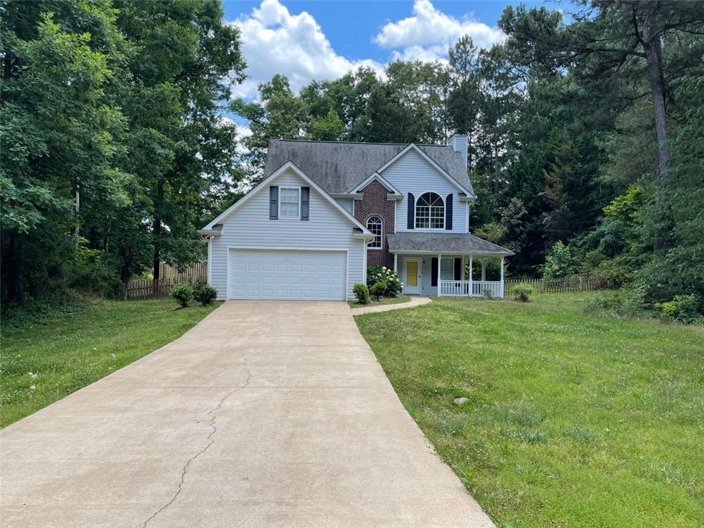 55 The Falls Boulevard Covington, GA 30016 - Photo 2 of 20 a front view of a house with yard and green space