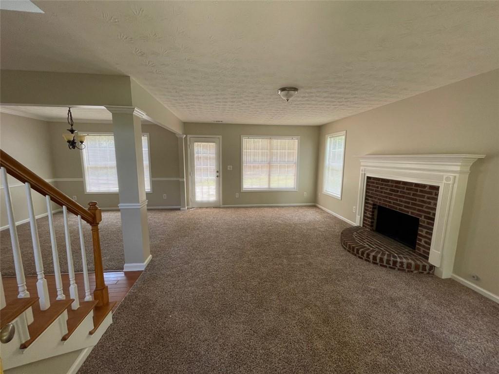 55 The Falls Boulevard Covington, GA 30016 - Photo 4 of 20 a view of a livingroom with a fireplace and window