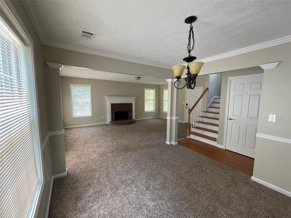 55 The Falls Boulevard Covington, GA 30016 - Photo 6 of 20 a view of empty room with fireplace and stairs