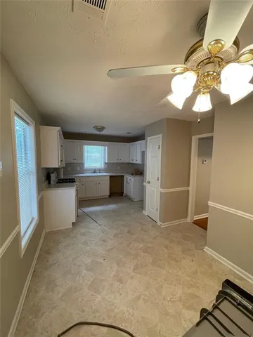 a kitchen with stainless steel appliances a refrigerator and a stove top oven