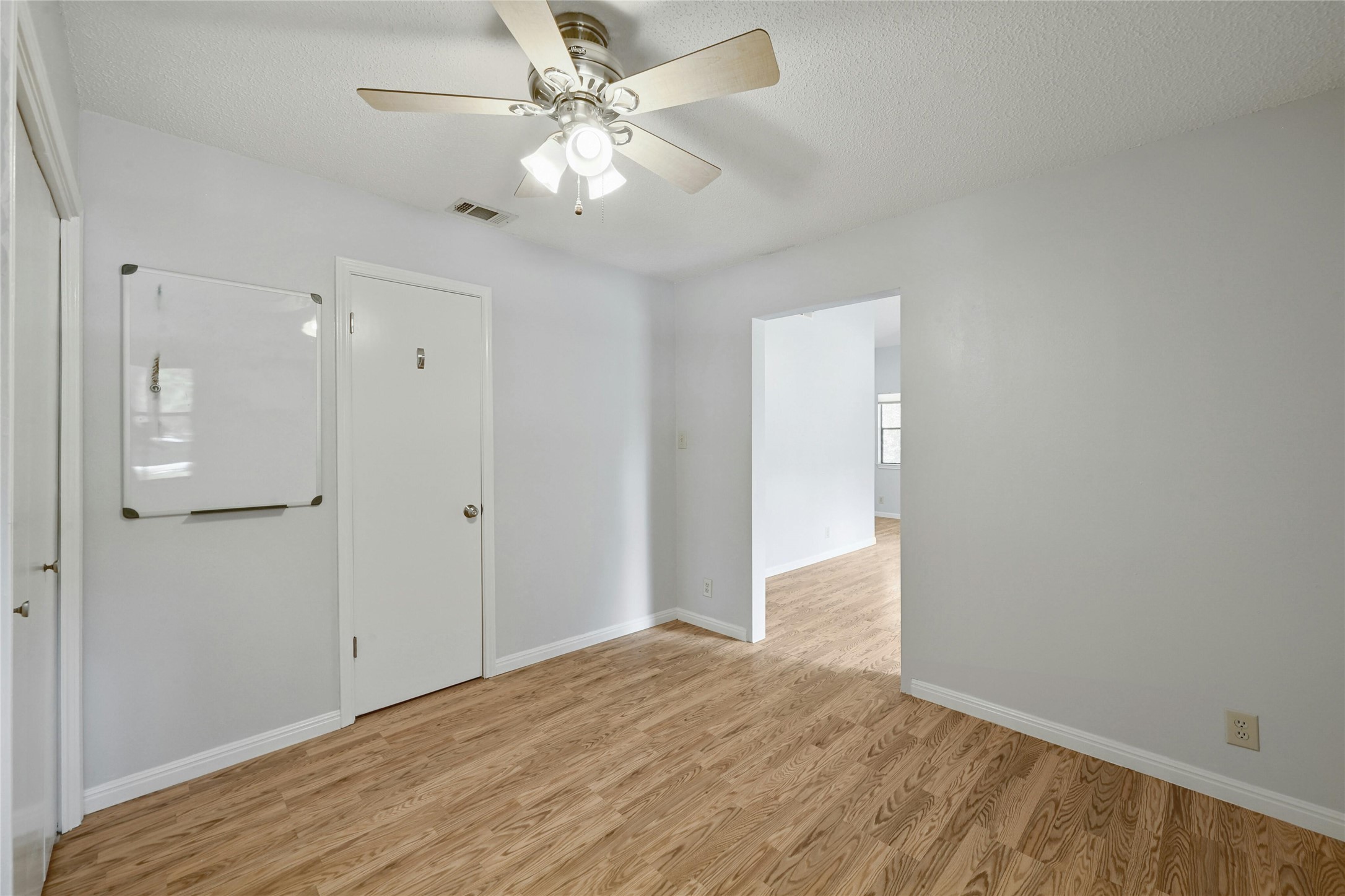 9226 Jollyville Road, Unit 221 Austin, TX 78759 - Photo 14 of 20 A well-lit area featuring durable wood flooring and a refreshing ceiling fan.
