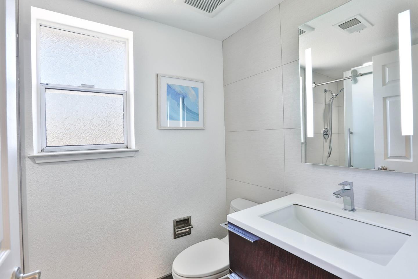 22344 McClellan Road Cupertino, CA 95014 - Photo 18 of 42 a bathroom with a sink toilet and mirror
