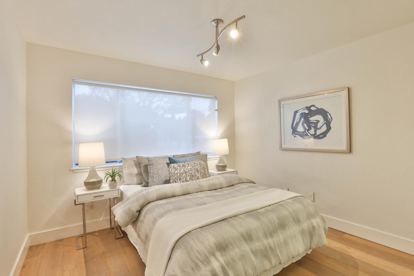 22344 McClellan Road Cupertino, CA 95014 - Photo 20 of 42 a bedroom with a large bed and a lamp