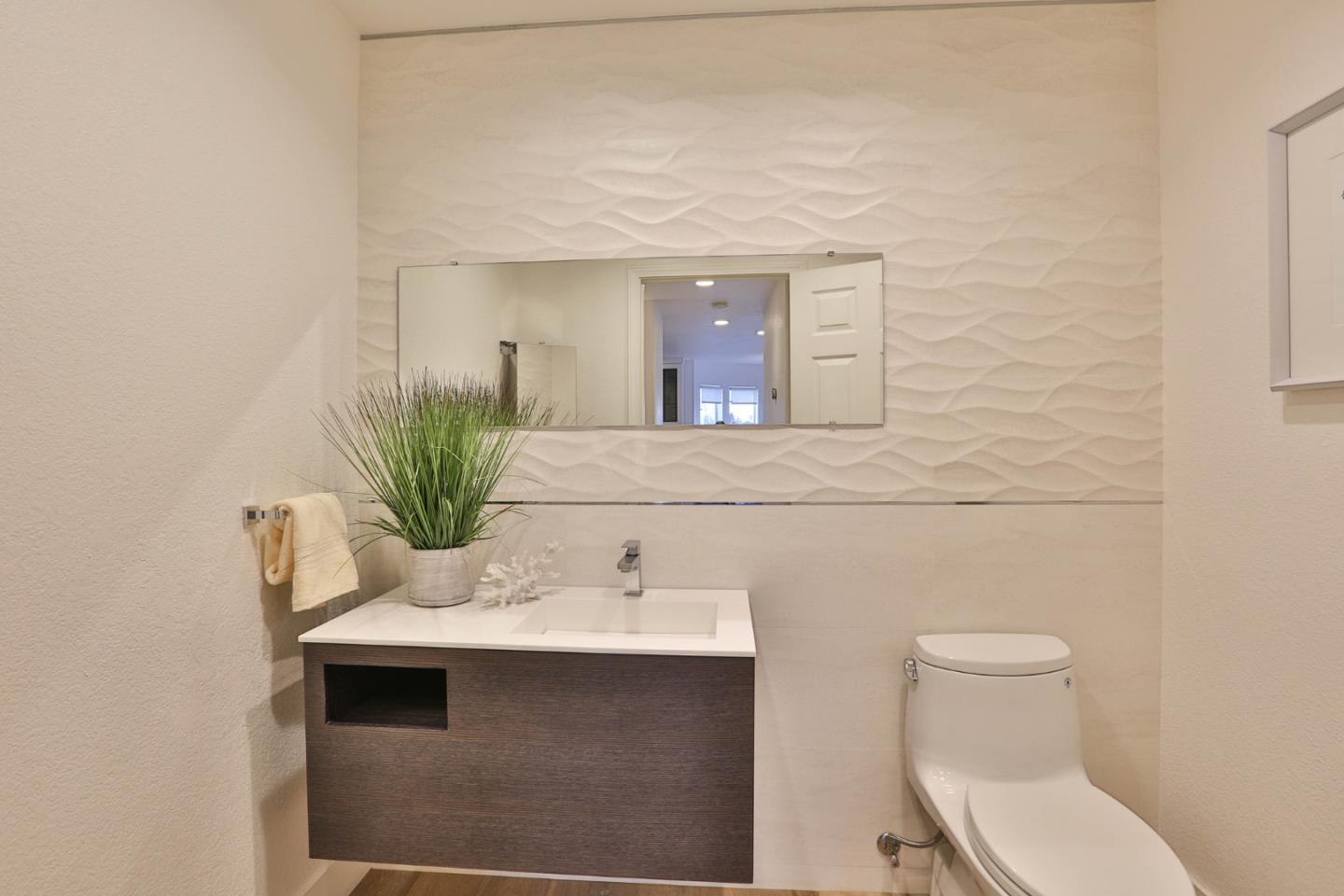 22344 McClellan Road Cupertino, CA 95014 - Photo 23 of 42 a bathroom with a toilet a sink and mirror