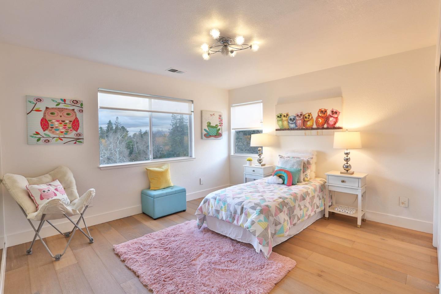 22344 McClellan Road Cupertino, CA 95014 - Photo 24 of 42 a bedroom with a bed and a chandelier