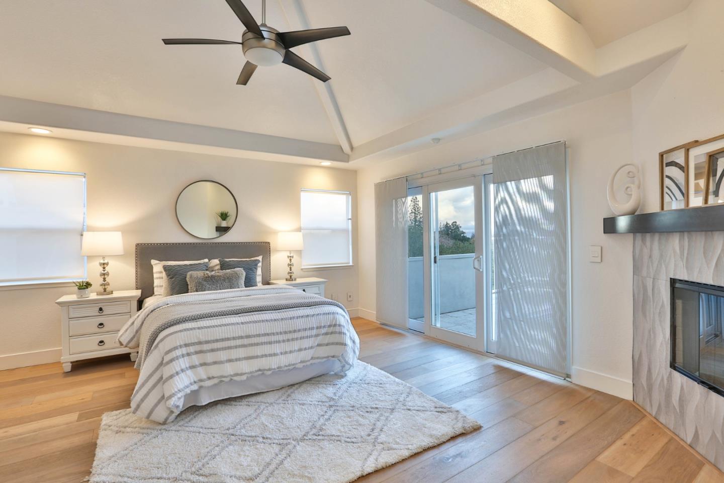 22344 McClellan Road Cupertino, CA 95014 - Photo 26 of 42 a bedroom with a large bed and a chandelier