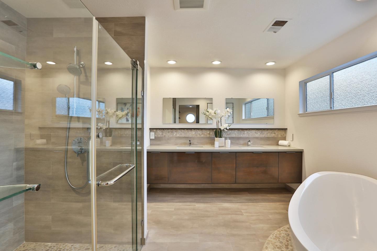 22344 McClellan Road Cupertino, CA 95014 - Photo 29 of 42 a spacious bathroom with a mirror and a shower