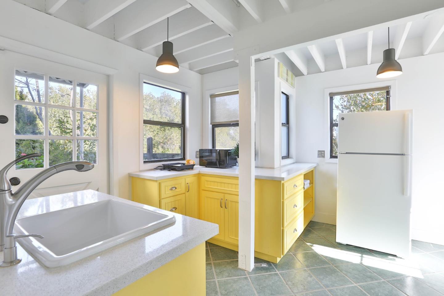 22344 McClellan Road Cupertino, CA 95014 - Photo 33 of 42 a room with a large window and a refrigerator